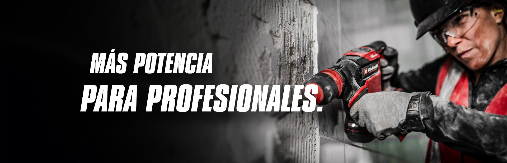 Una persona con gafas de seguridad y casco utilizando un taladro rojo sobre una pared, con el texto "Más Potencia para Profesionales."