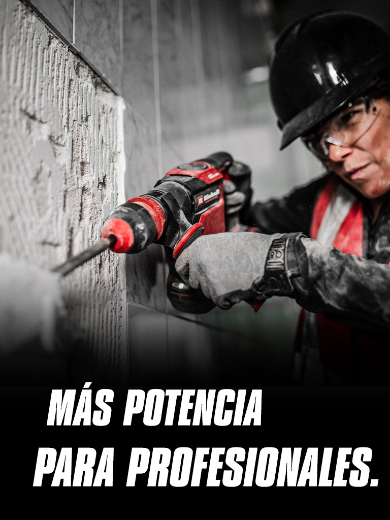 Una persona con gafas de seguridad y casco utilizando un taladro rojo sobre una pared, con el texto "Más Potencia para Profesionales."