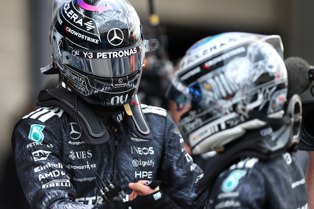 Dos pilotos Mercedes F1 con trajes de competición y cascos