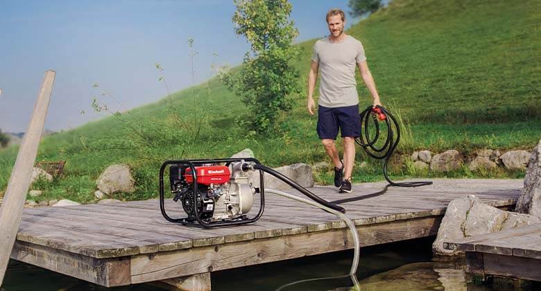 man working with a petrol water pump