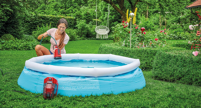 woman using a submersible clear water pump in a pool
