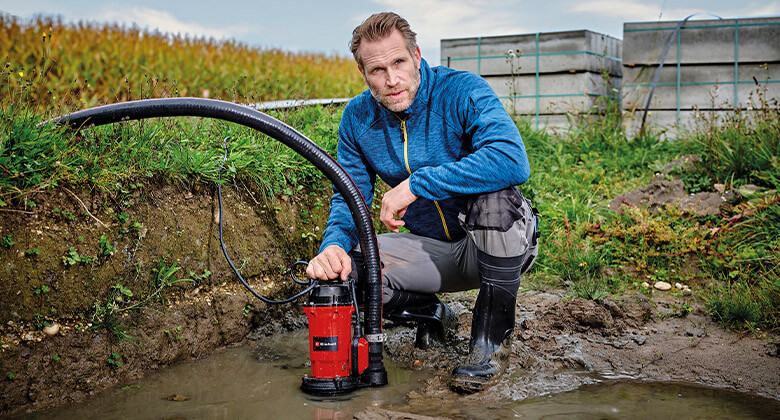 man with a submersible dirt water pump