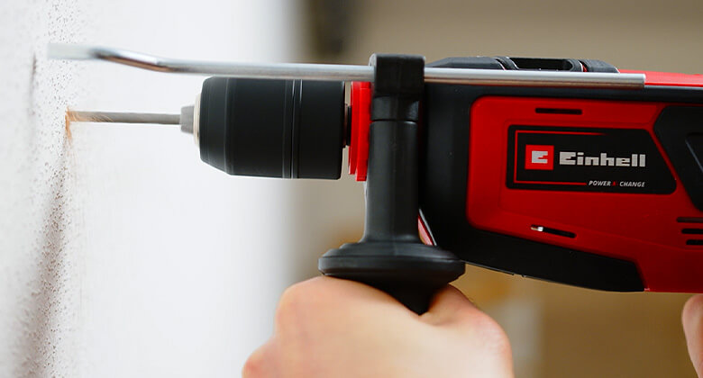 Einhell impact driller drilling a hole into a wall